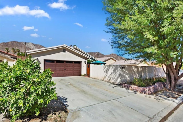 view of front of house with a mountain view and a garage