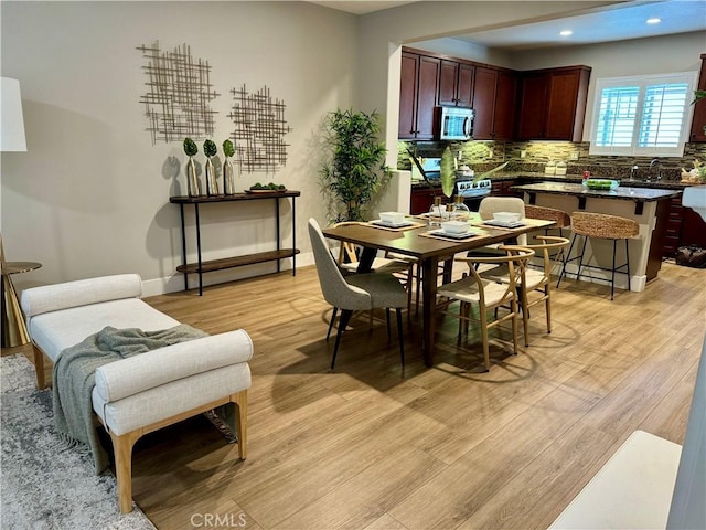 dining area with light hardwood / wood-style floors