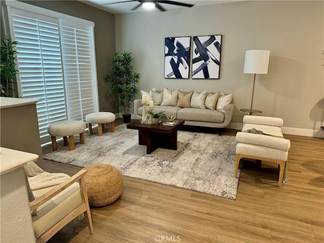 living room featuring ceiling fan and light hardwood / wood-style floors