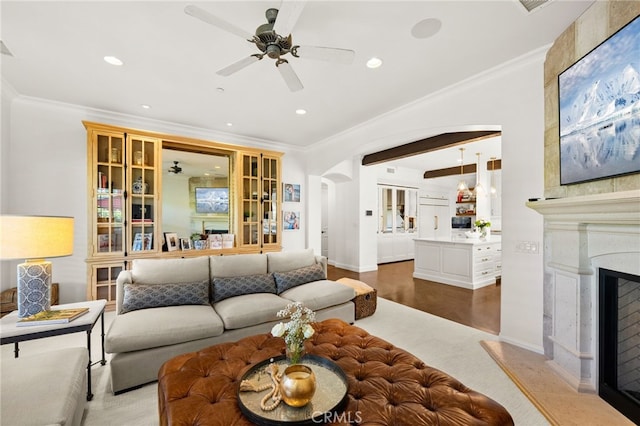 living room featuring ornamental molding, hardwood / wood-style flooring, and a high end fireplace