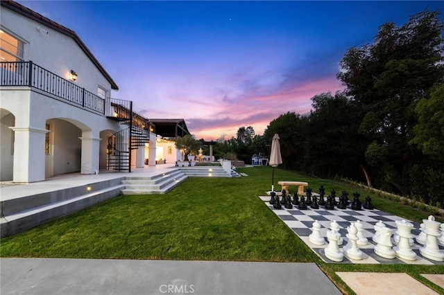 yard at dusk with a patio area