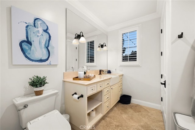 bathroom featuring toilet, ornamental molding, and vanity