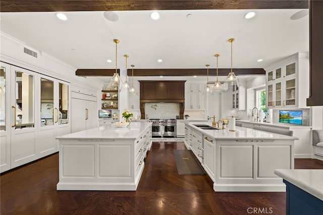 kitchen with a large island, tasteful backsplash, sink, and pendant lighting