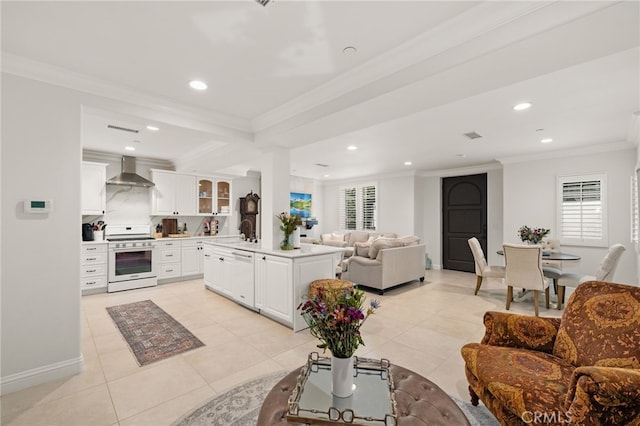 kitchen featuring white appliances, wall chimney exhaust hood, white cabinetry, and ornamental molding