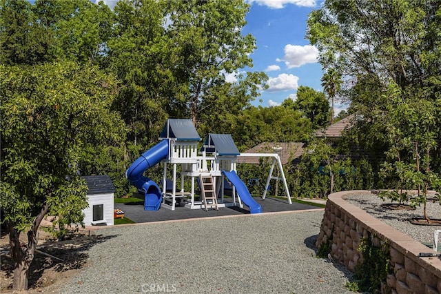 view of jungle gym with a storage unit