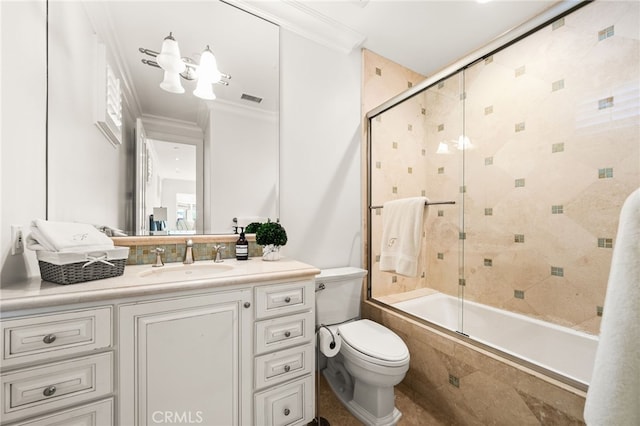 full bathroom with vanity, ornamental molding, shower / bath combination with glass door, and toilet