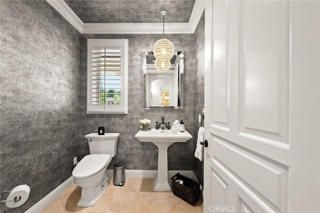 bathroom with toilet, ornamental molding, and tile patterned flooring