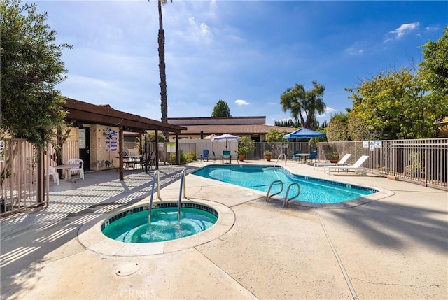 view of swimming pool with a patio and a community hot tub