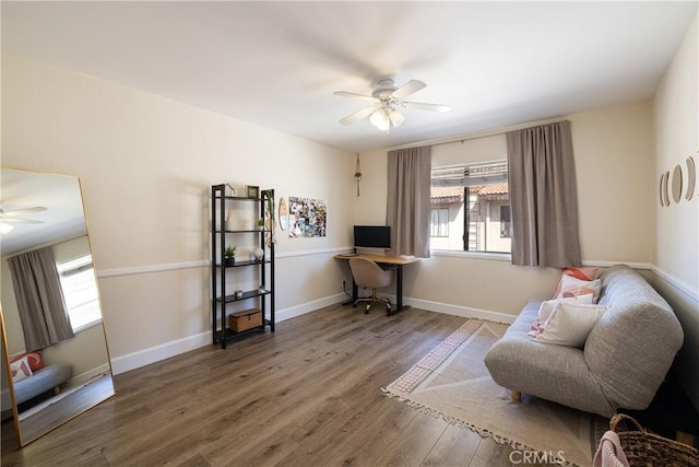 living area with ceiling fan, a healthy amount of sunlight, and hardwood / wood-style floors