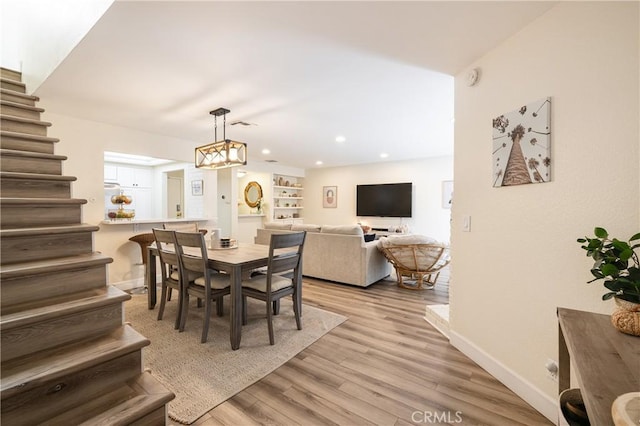 dining area featuring a chandelier and light hardwood / wood-style flooring