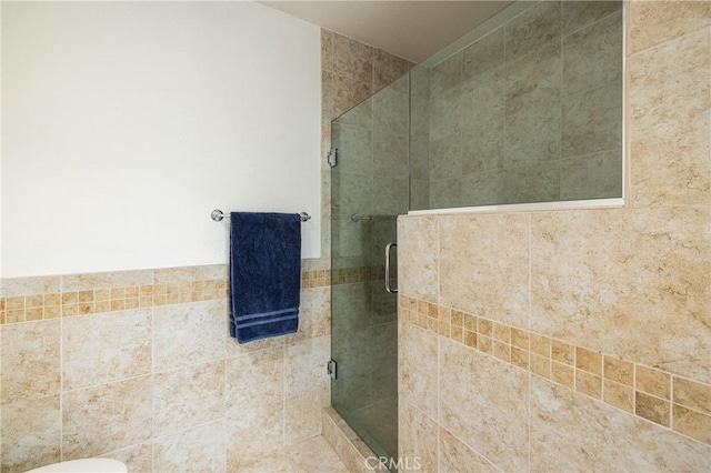 bathroom featuring a shower with shower door