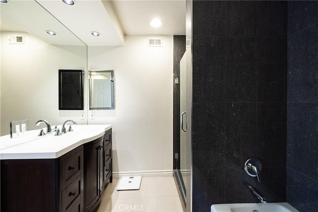 bathroom featuring tub / shower combination, vanity, and tile patterned flooring