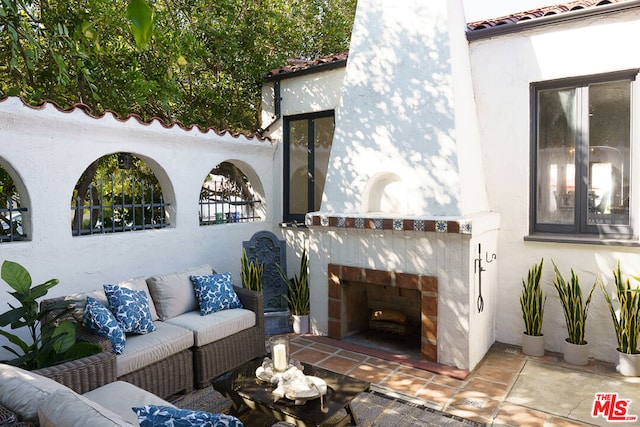 view of patio featuring an outdoor living space with a fireplace