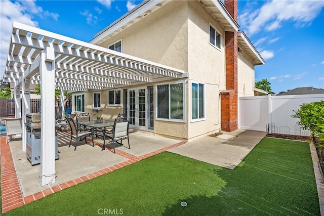 rear view of house with a pergola and a patio