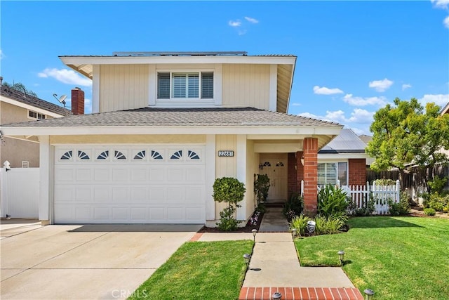 view of front of home featuring a front lawn and a garage