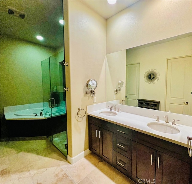 bathroom with vanity and separate shower and tub