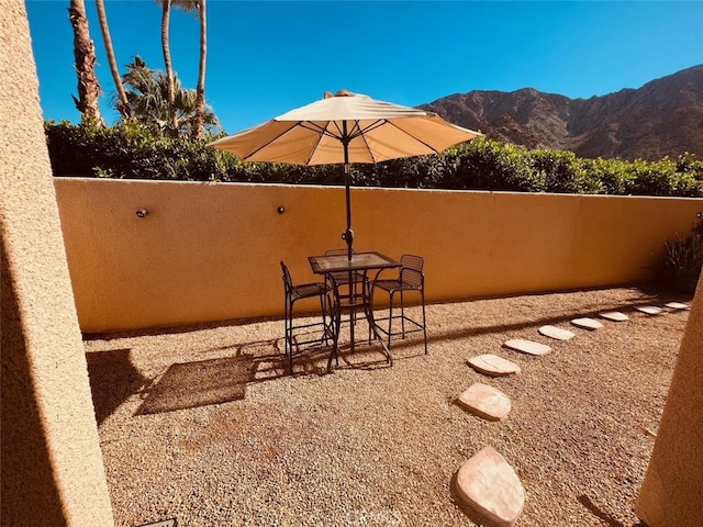 view of patio / terrace featuring a mountain view