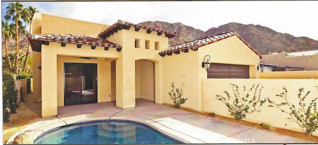 view of swimming pool featuring a mountain view and a patio area