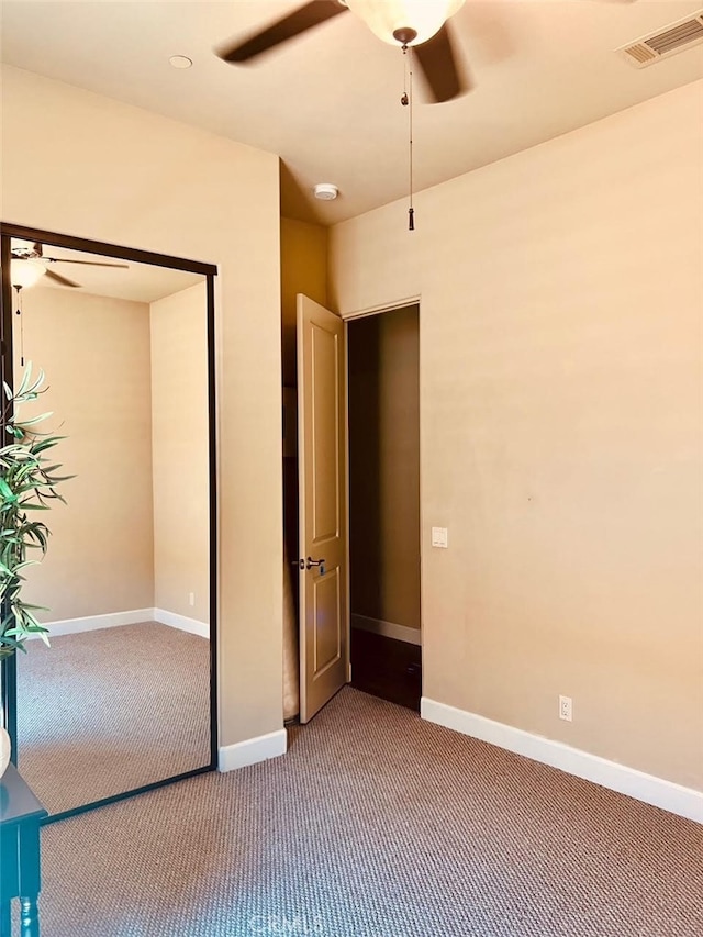 unfurnished bedroom featuring carpet floors and ceiling fan