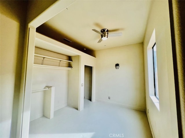 unfurnished bedroom with ceiling fan and a closet