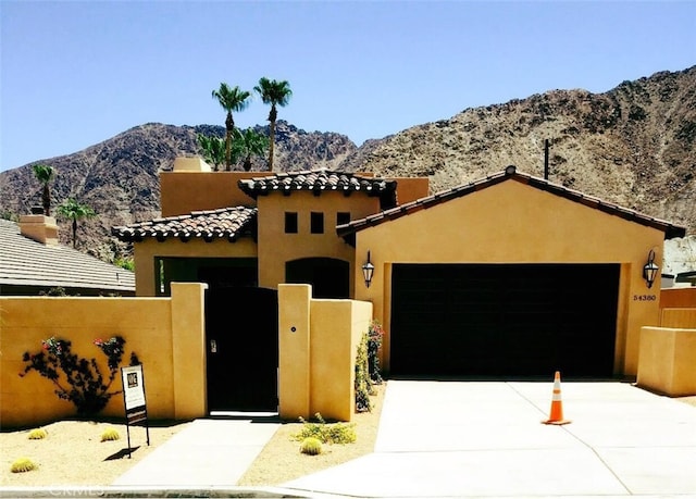 view of front facade with a mountain view and a garage