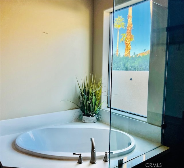 bathroom featuring tiled bath