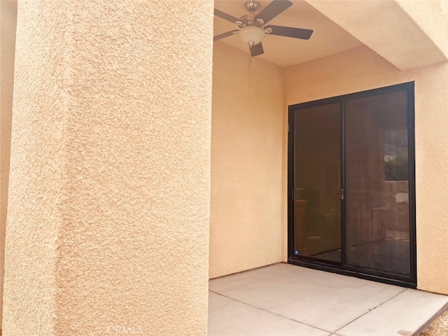 doorway to property featuring ceiling fan