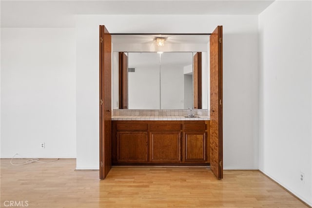 bathroom with vanity and hardwood / wood-style flooring