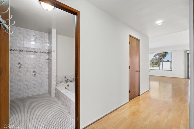 corridor with hardwood / wood-style floors