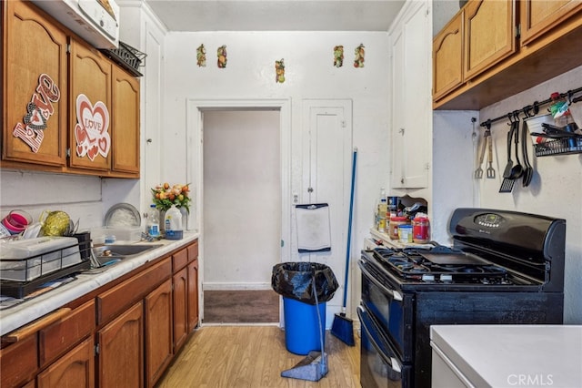 kitchen featuring light hardwood / wood-style flooring and black range with gas stovetop