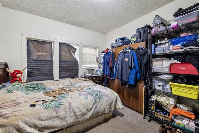 carpeted bedroom featuring a textured ceiling