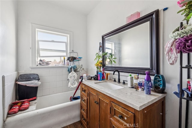 bathroom with vanity, a tub to relax in, and hardwood / wood-style floors