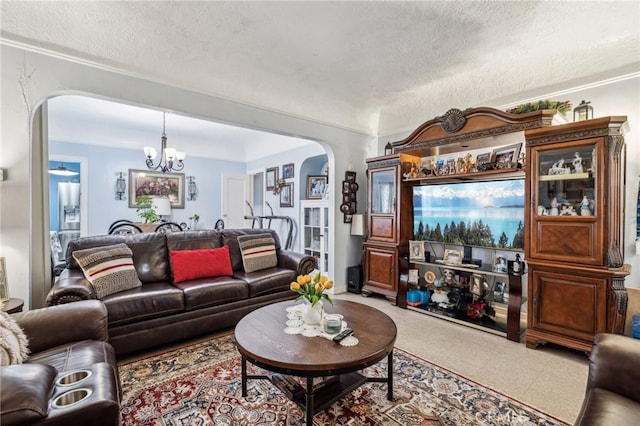 living room with a textured ceiling and a chandelier