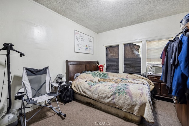 bedroom featuring a textured ceiling, carpet, and cooling unit