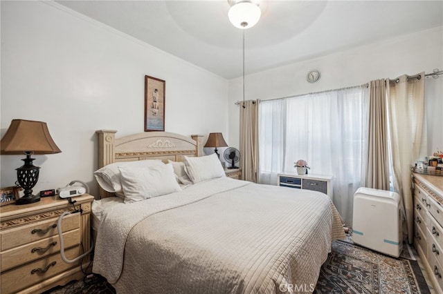 bedroom with ornamental molding and ceiling fan