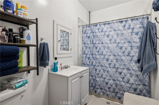 bathroom featuring walk in shower, vanity, and toilet