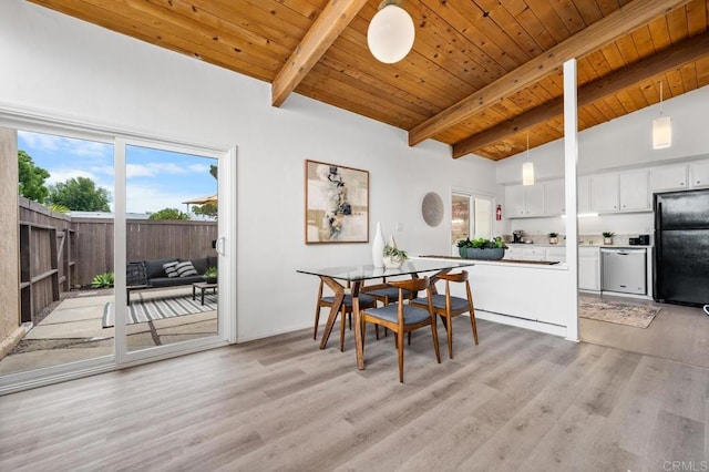 dining room featuring vaulted ceiling with beams, light hardwood / wood-style flooring, and wooden ceiling