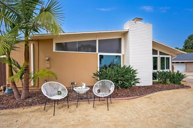 back of property with a patio