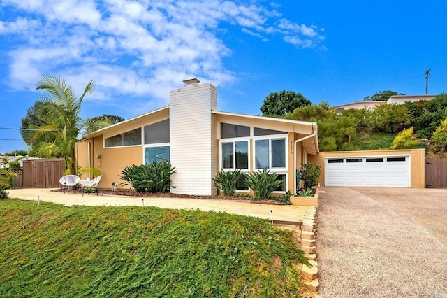 view of front of home with a garage and a front yard