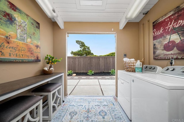 clothes washing area with wooden ceiling and independent washer and dryer