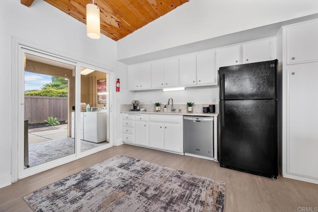 kitchen with black fridge, dishwasher, pendant lighting, washing machine and dryer, and white cabinets