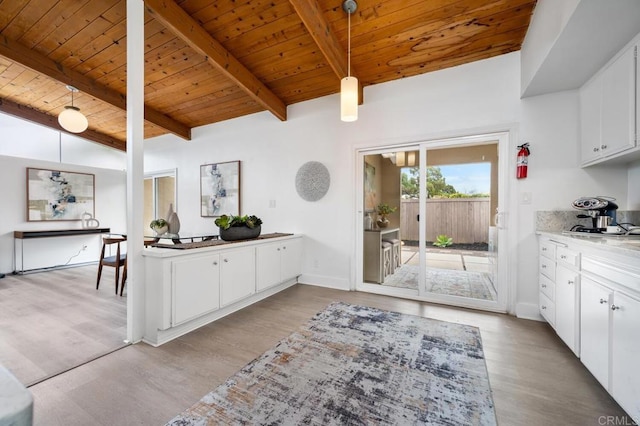 kitchen featuring white cabinetry, wood ceiling, hanging light fixtures, and light hardwood / wood-style flooring