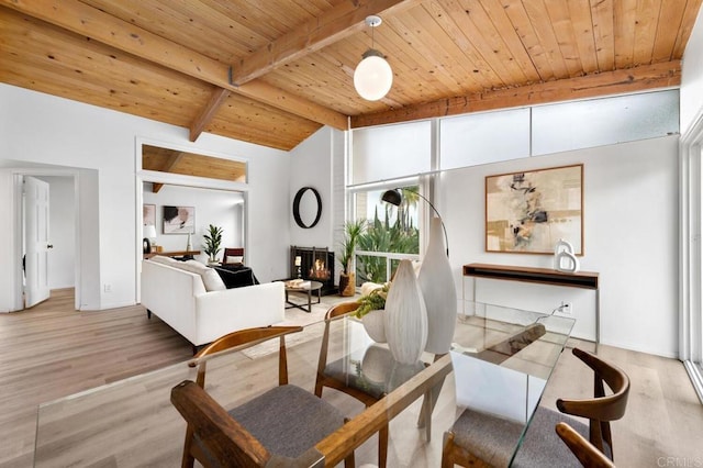 sitting room with wood ceiling, light hardwood / wood-style flooring, and lofted ceiling with beams