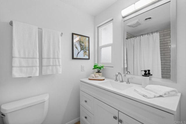 bathroom featuring vanity, a shower with curtain, and toilet