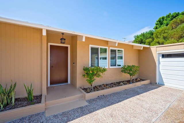 view of exterior entry featuring a garage