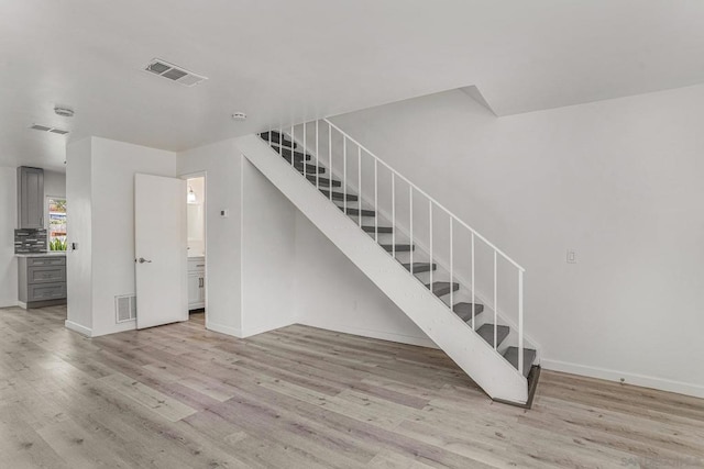 stairs with hardwood / wood-style floors