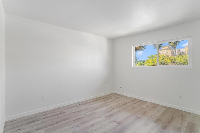 unfurnished room with light wood-type flooring