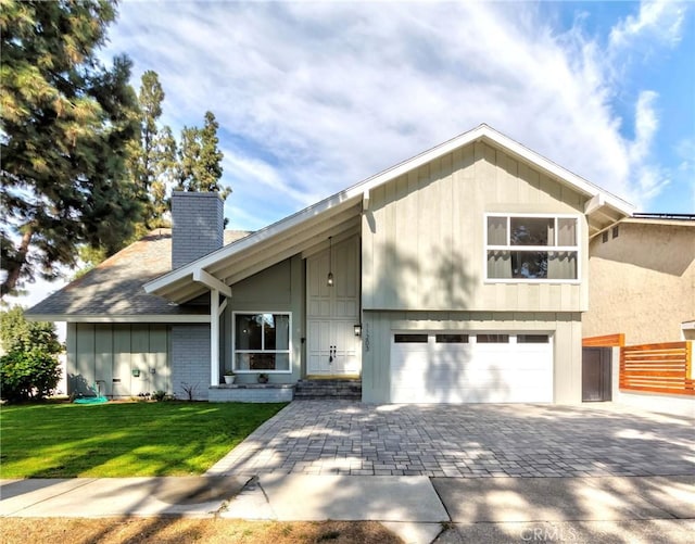 view of front of home featuring a garage and a front lawn