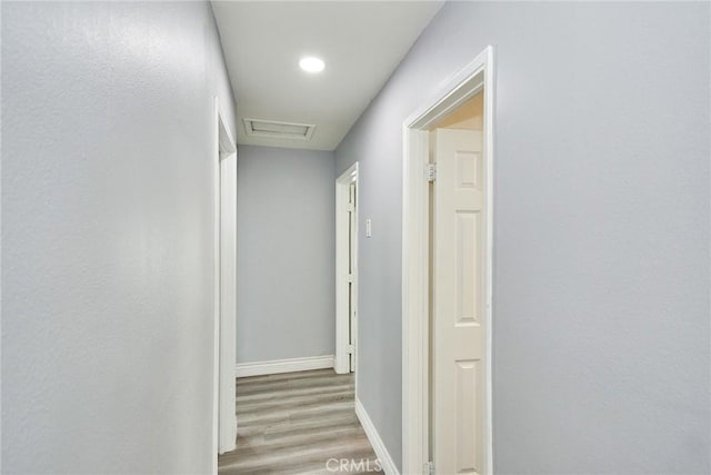 hallway with hardwood / wood-style floors