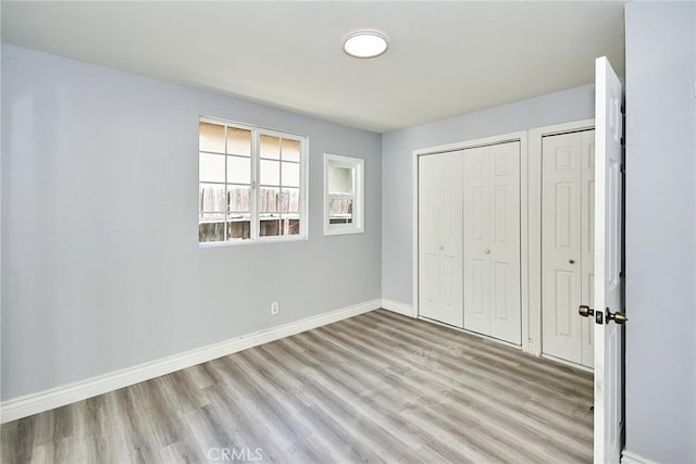 unfurnished bedroom with light wood-type flooring